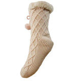 Beige knitted sock with cable pattern and fluffy top on a white background