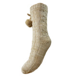 Beige knitted sock with a pom-pom on a white background