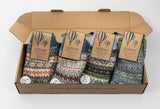 Box of GemJar socks with colorful patterns and brand tags on a white background