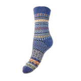 Blue knitted sock with a Fairisle pattern on a white background